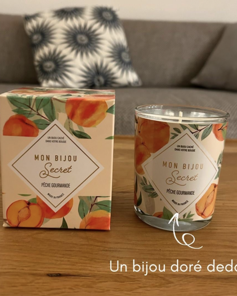 Bougie parfumée artisanale contenant un bijou surprise à l’intérieur, posée sur une table